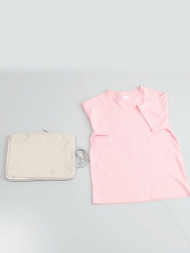 Frame at 9 seconds from the supplier video: beige organizer beside a pink shirt; another listing variant, not our selected lake-blue set.
